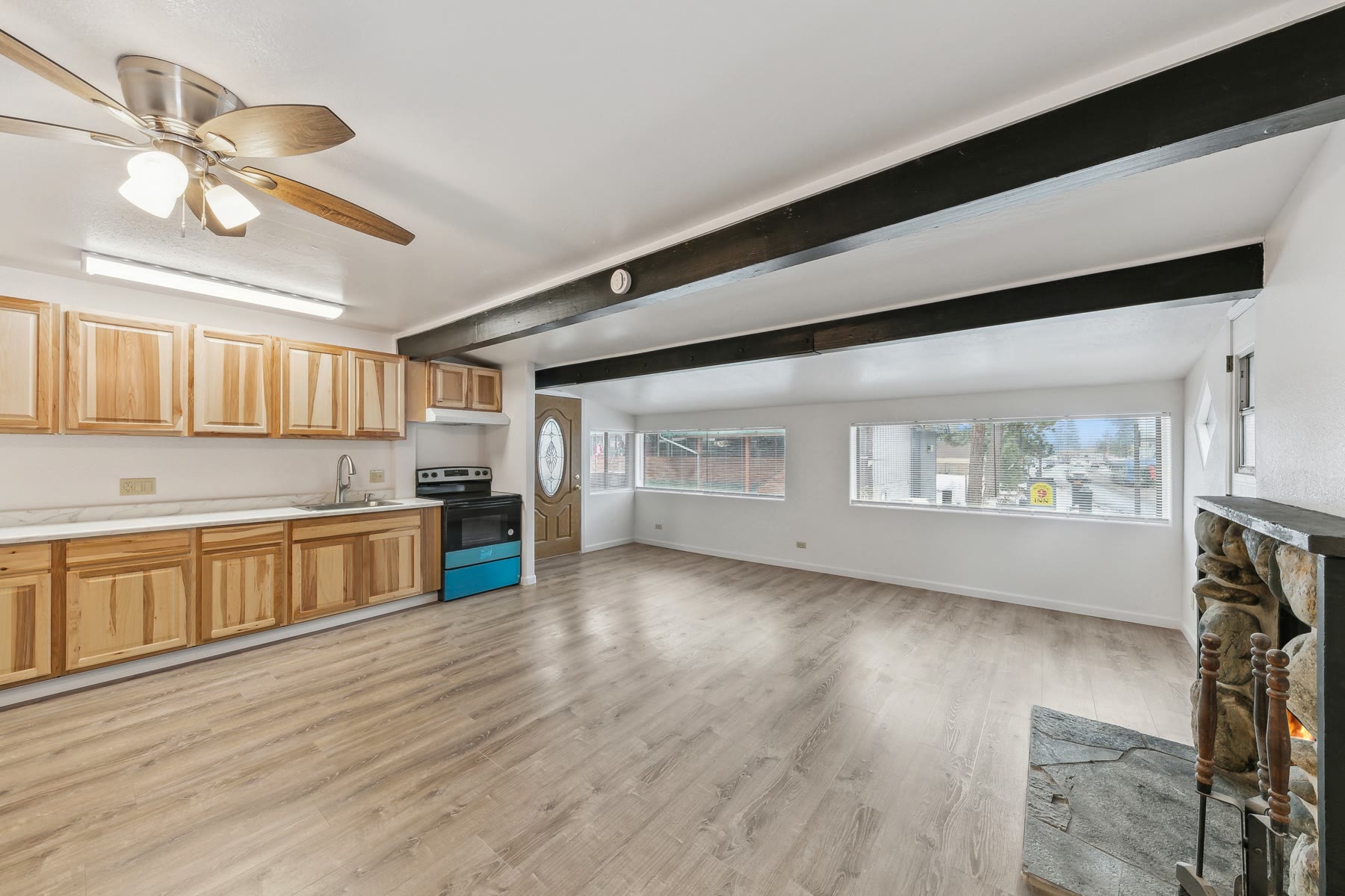 Remodeled apartment with new flooring, wood cabinets and an open living area